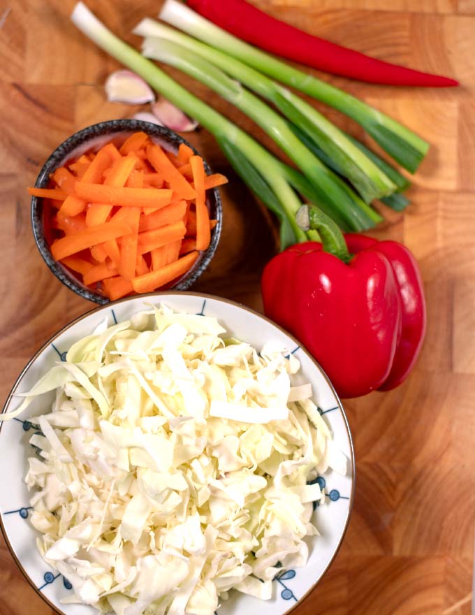 Ingredients needed to make Jamaican Cabbage on a board.