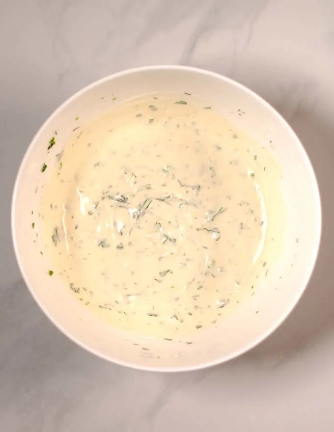 Top view of a large mixing bowl with Keto Ranch Dressing.
