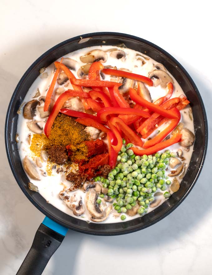 Top view of a pan with the ingredients of this Mushroom Curry.