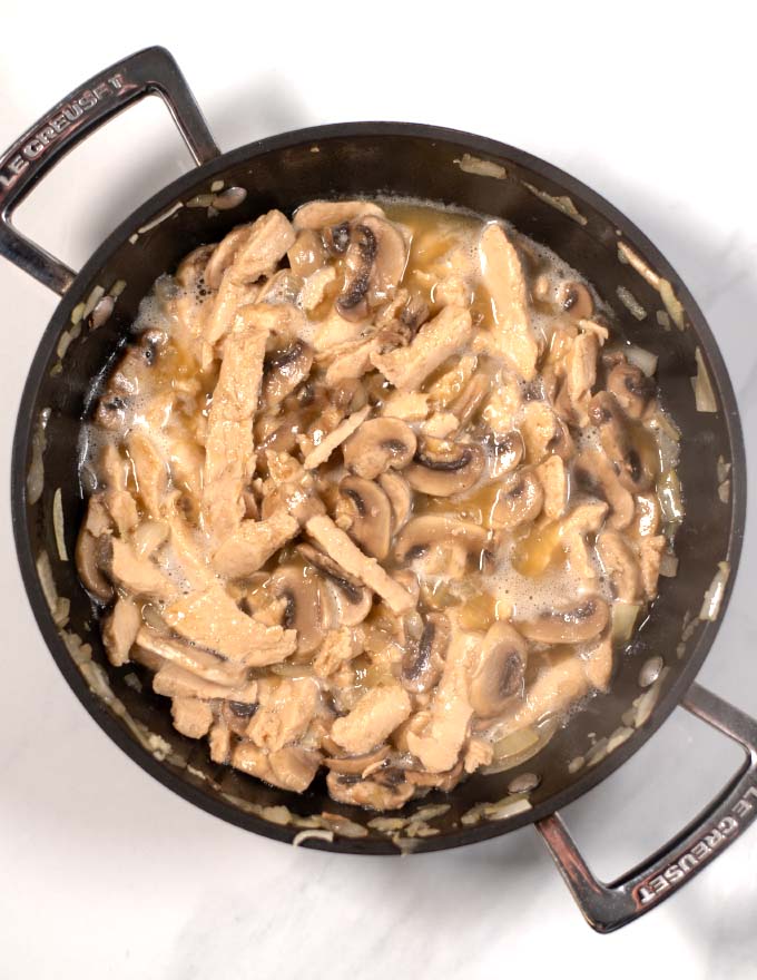 Vegan chicken strips are added to a skillet.