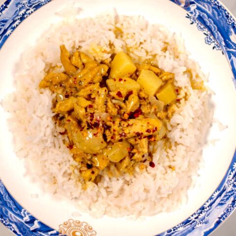 A serving of Jamaican Curry Chicken served with rice.