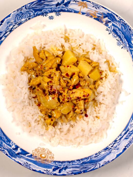 A serving of Jamaican Curry Chicken served with rice.