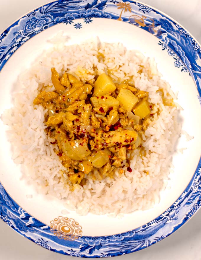 A serving of Jamaican Curry Chicken served with rice.