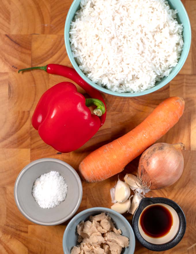 Ingredients needed to make Thai Fried Rice collected on a board.