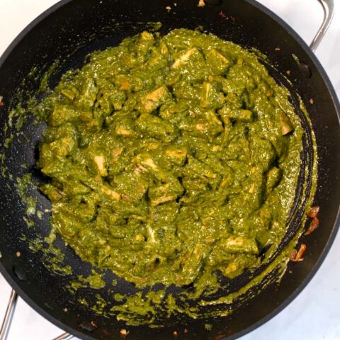 Top view of a large pan with the Chicken Spinach Curry.