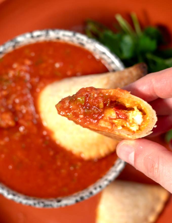 Open empanada after dipped in sauce.