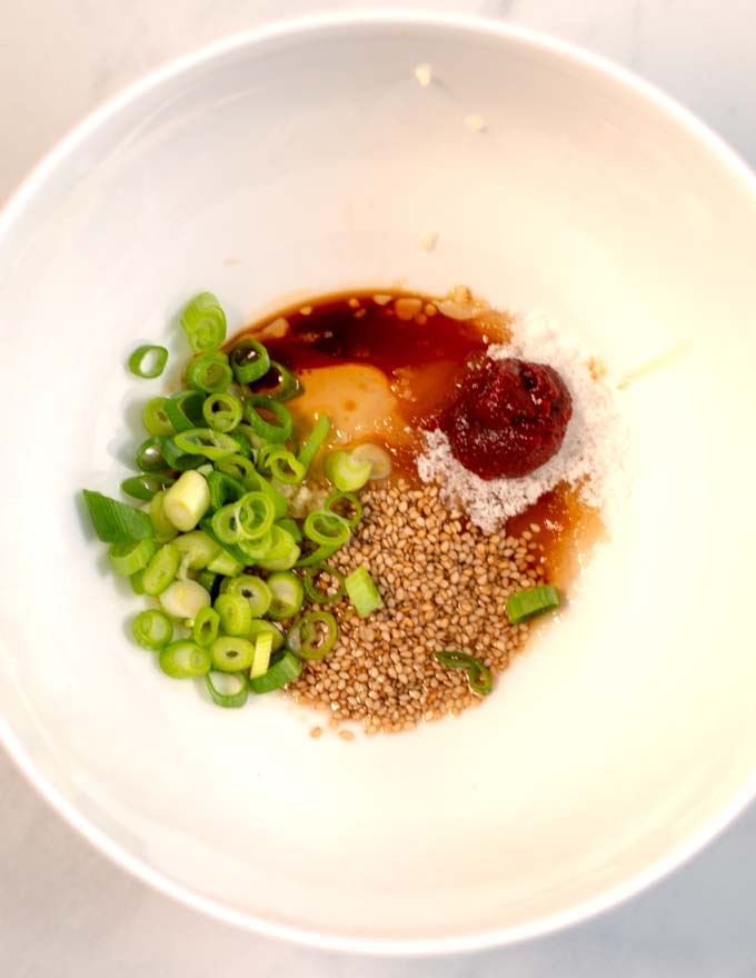 View of the dressing ingredients in a mixing bowl.