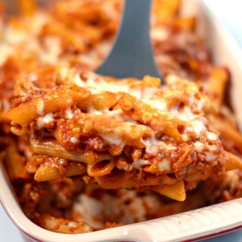 A large portion of Lasagna Casserole is lifted from the baking dish.