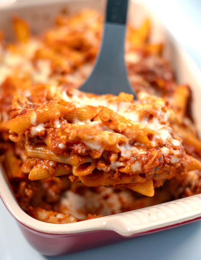 A large portion of Lasagna Casserole is lifted from the baking dish.