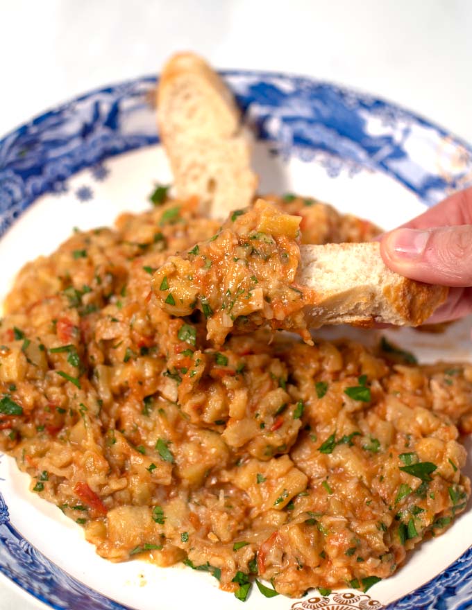 Closeup of bread dipped in Zaalouk.