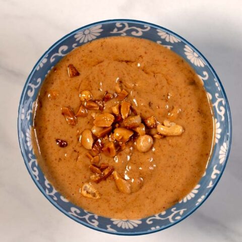 Top view on a serving bowl with Vietnamese Peanut Sauce.