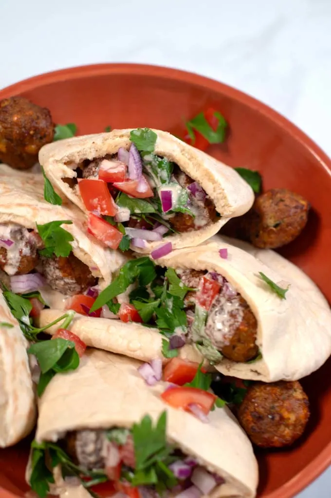 A large plate with Falafel Pita Sandwich.