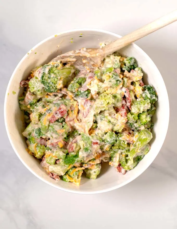 Top view of a mixing bowl with leftover broccoli casserole ingredients.
