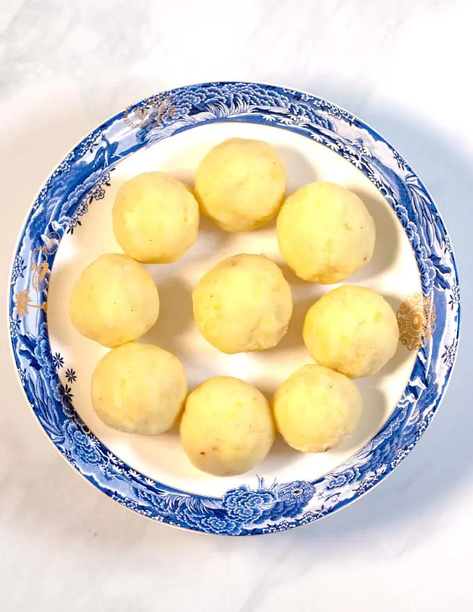 A large plate of Puerto Rican Stuffed Potato Balls before frying.