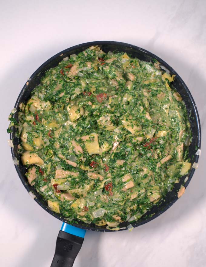 After mixing in the dairy-free sour cream, the Chicken Artichoke Casserole is ready for baking.