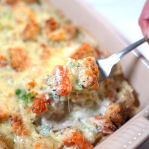 A fork lifts a bite of the Keto Chicken Vegetable Casserole.