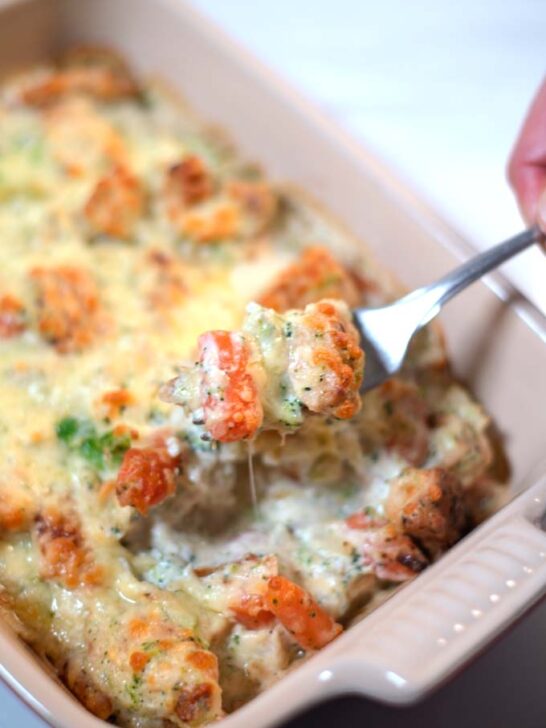 A fork lifts a bite of the Keto Chicken Vegetable Casserole.
