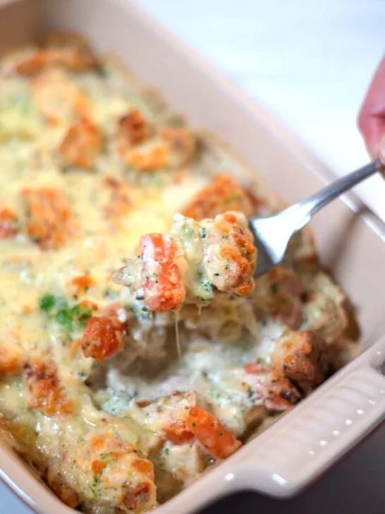 A fork lifts a bite of the Keto Chicken Vegetable Casserole.