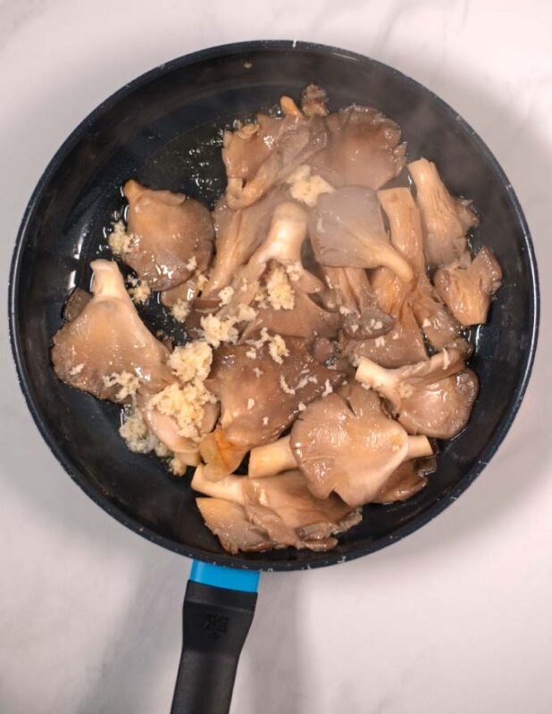 Pressed garlic is added to the pan.