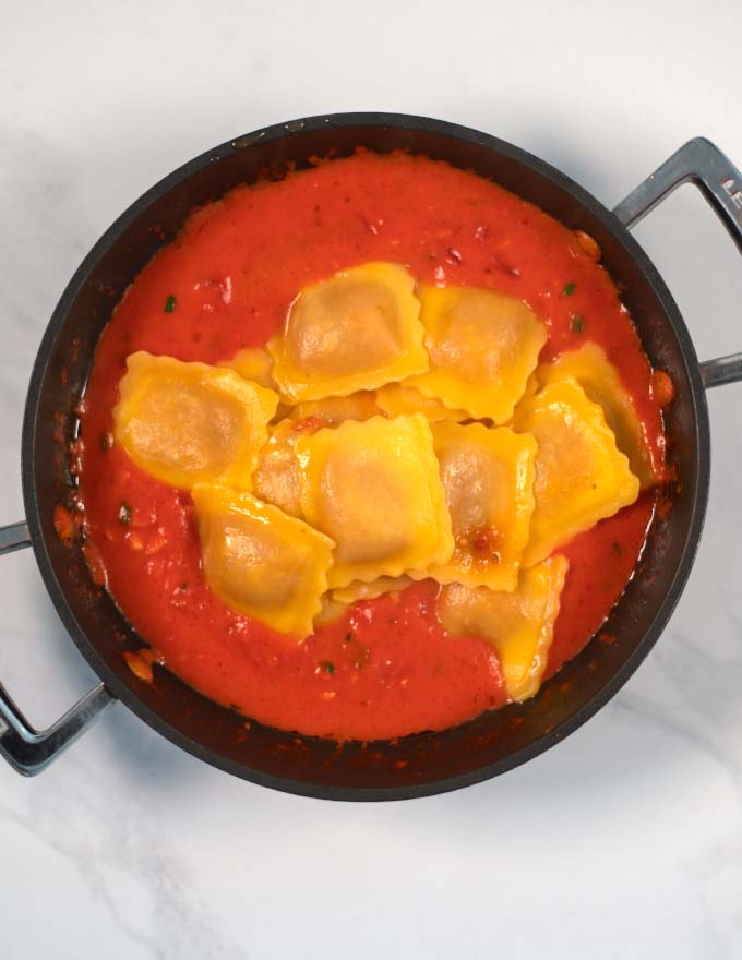 Cooked ravioli are given into the sauce.