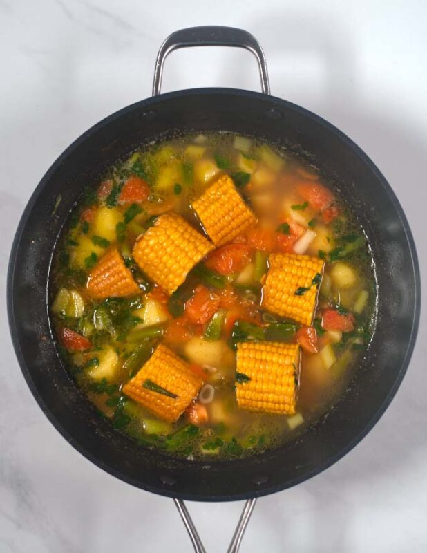 Corn cobs are given into the Sancocho.