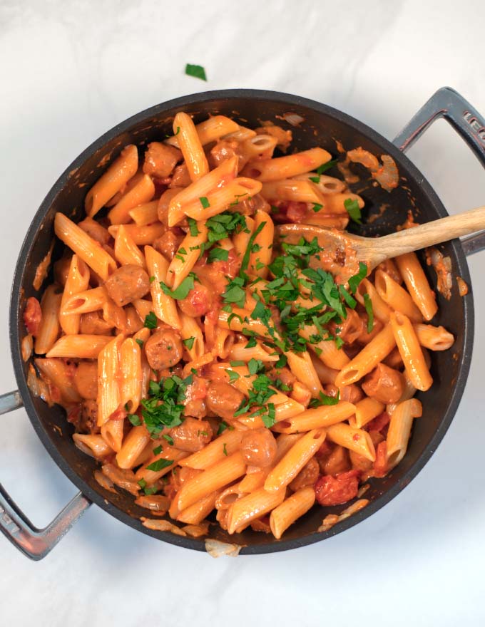 Hot Dog Pasta in a pan, garnished with fresh parsley.