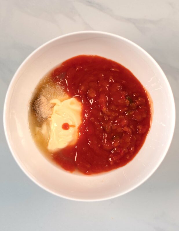 The liquid ingredients for the salad dressing are given into a larrge mixing bowl.