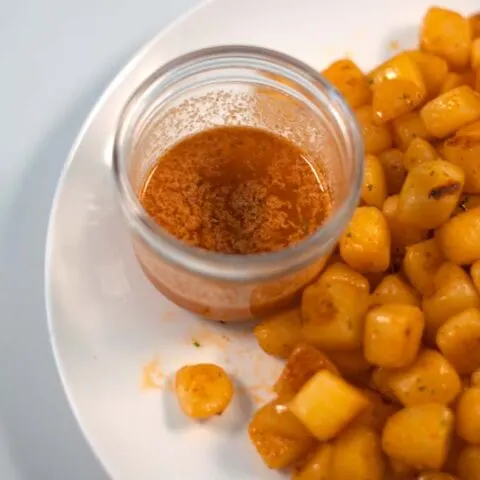 Closeup of Cajun Garlic Butter Sauce in a glass jar.