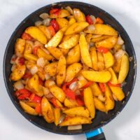 Ready Potatoes with Peppers and Onions in a pan.