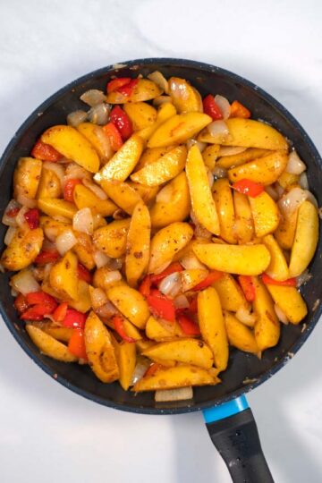 Ready Potatoes with Peppers and Onions in a pan.