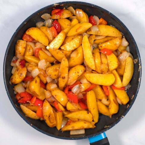 Ready Potatoes with Peppers and Onions in a pan.