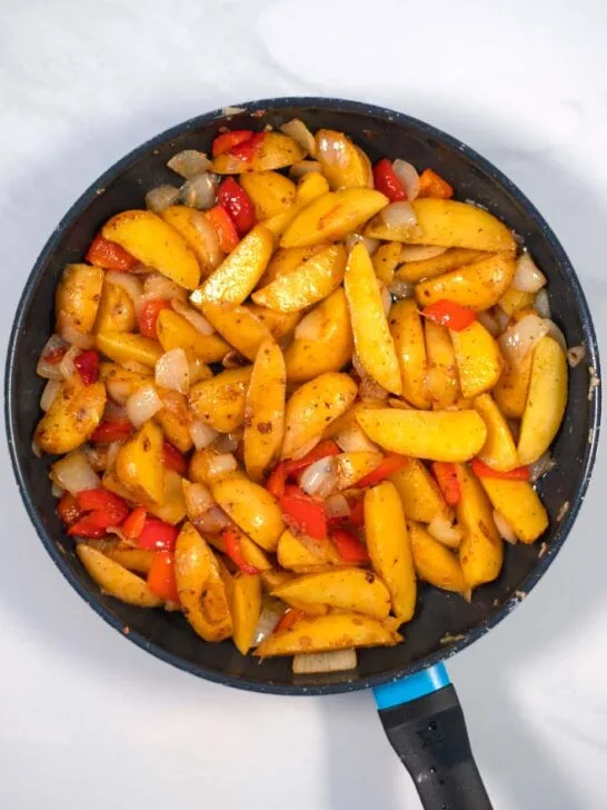 Ready Potatoes with Peppers and Onions in a pan.