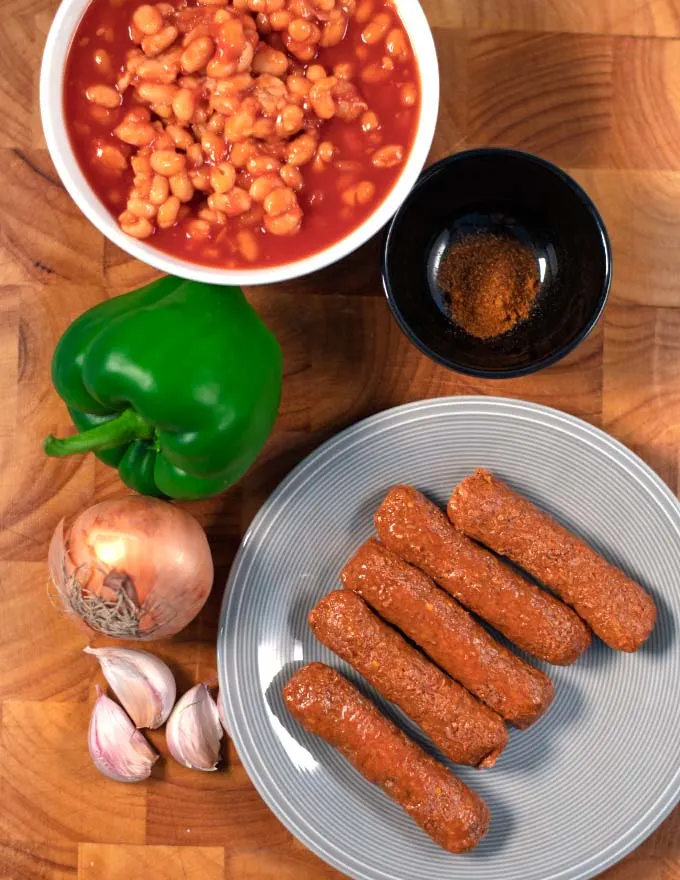 Ingredients needed to make Sausage Chili are collected on a board.