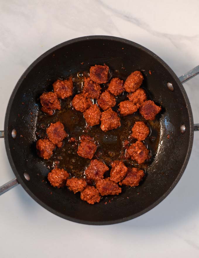 A pan with browned sausage bits.