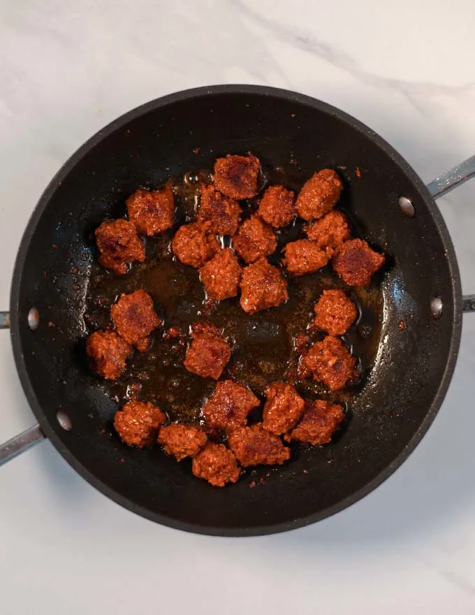 A pan with browned sausage bits.