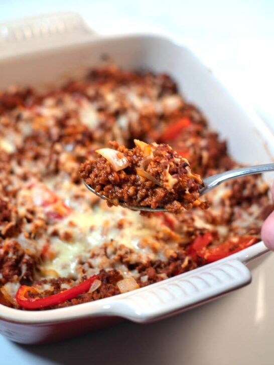 A spponful of Keto Sloppy Joe Casserole is lifted from the baking dish.