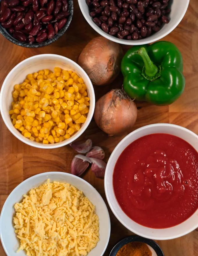 Ingredients needed for making mixed bean casserole are collected on a board.