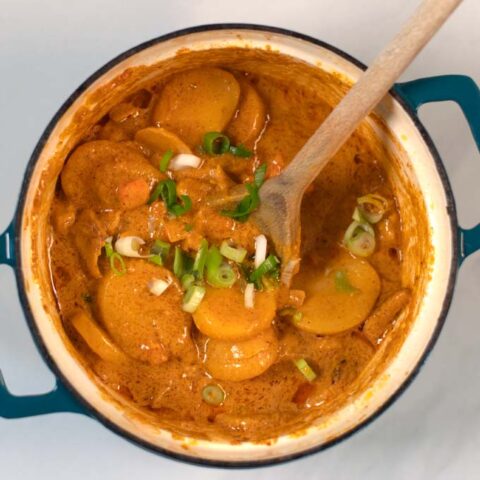 The ready Vietnamese Curry in a pot with a wooden spoon.