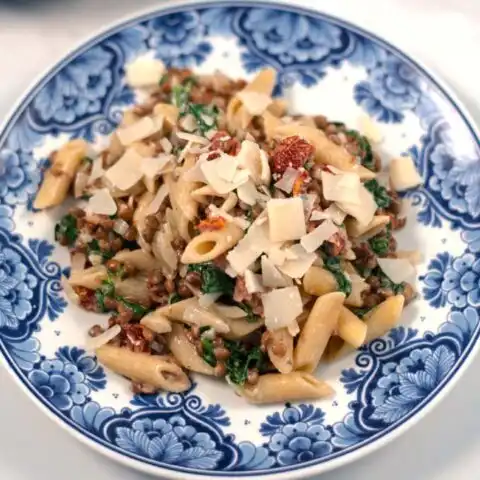 Fresh vegan parmesan flakes are used to top Marry Me Pasta.
