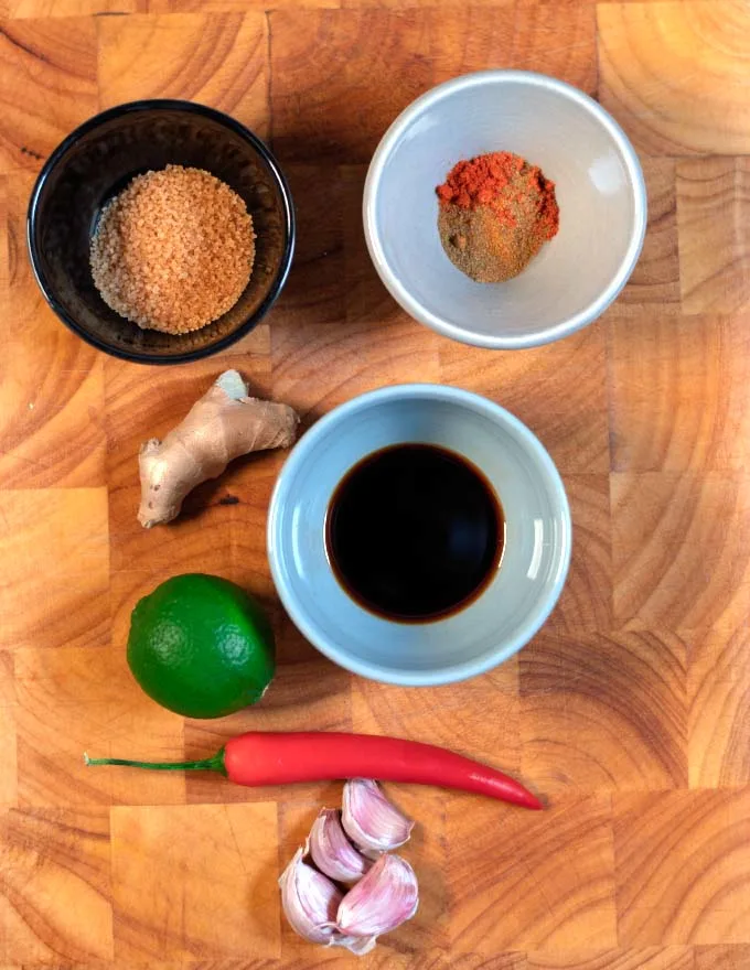 Ingredients needed to make Thai Seasoning Sauce on a wooden board.