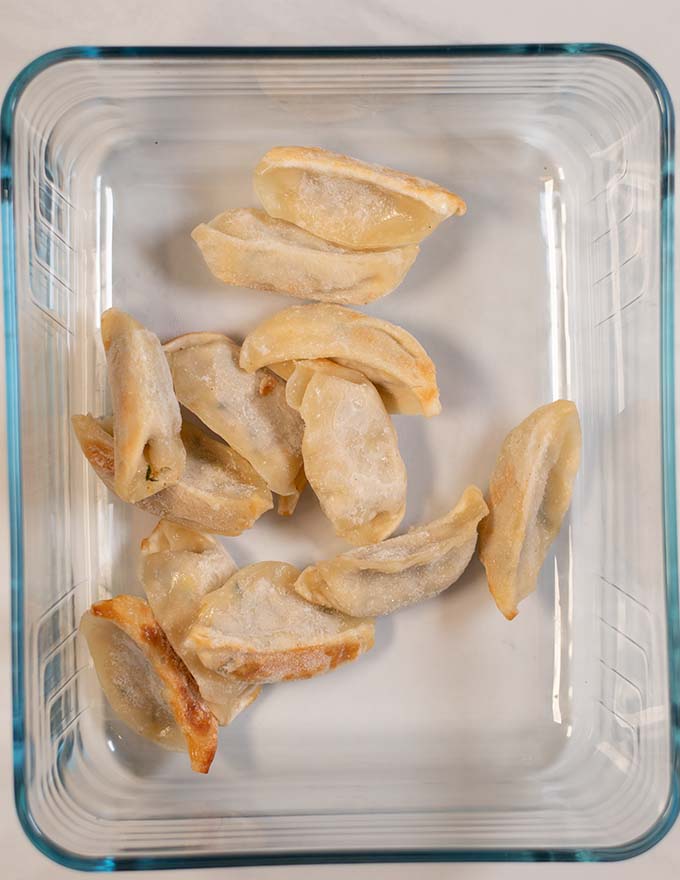 Frozen dumplings are given into a baking dish.