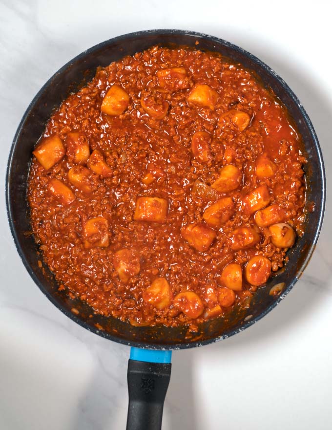 Somato sauce is added to the meat and onion mixture in the pan.