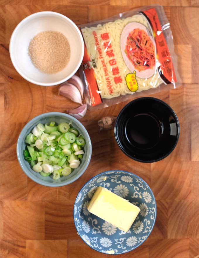 Ingredients needed to make Hibachi Noodles collected on a wooden board.