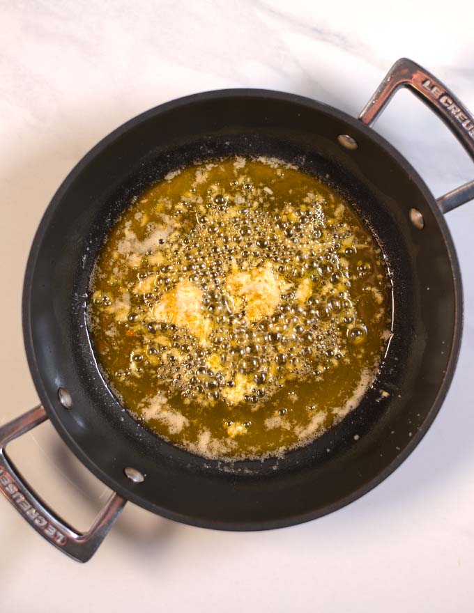 Garlic and ginger are sauteed in butter.