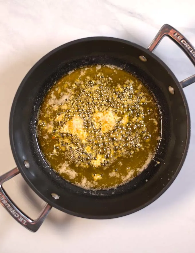 Garlic and ginger are sauteed in butter.