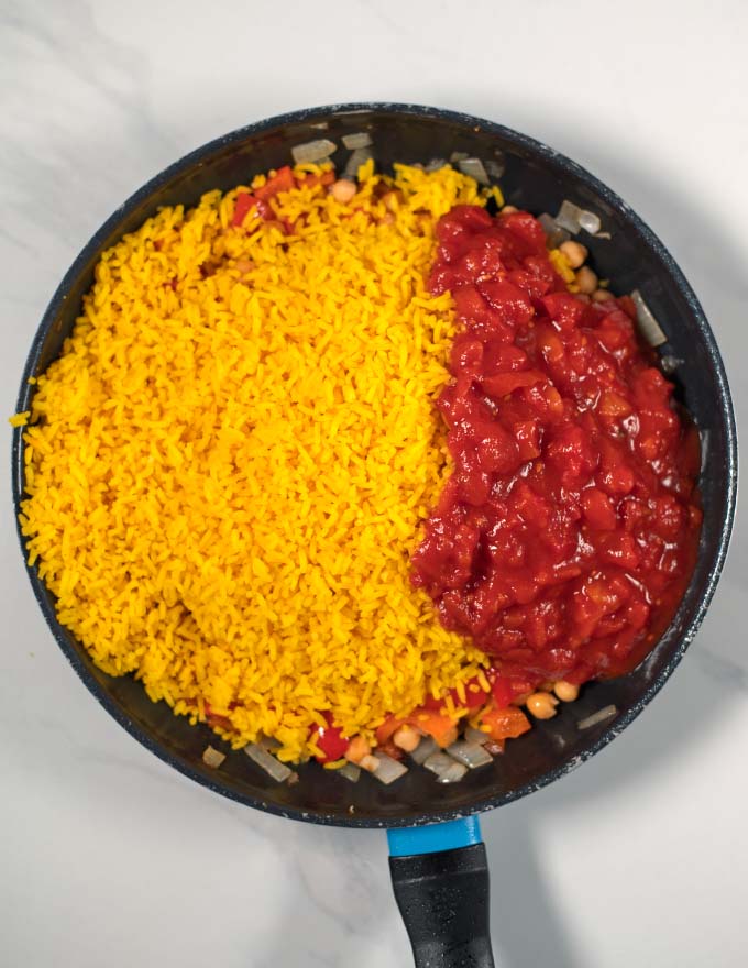 Leftover rice and baked tomatoes are given to the frying pan/