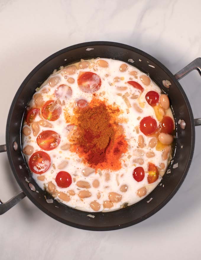 Spices are added to the butter bean sauce.