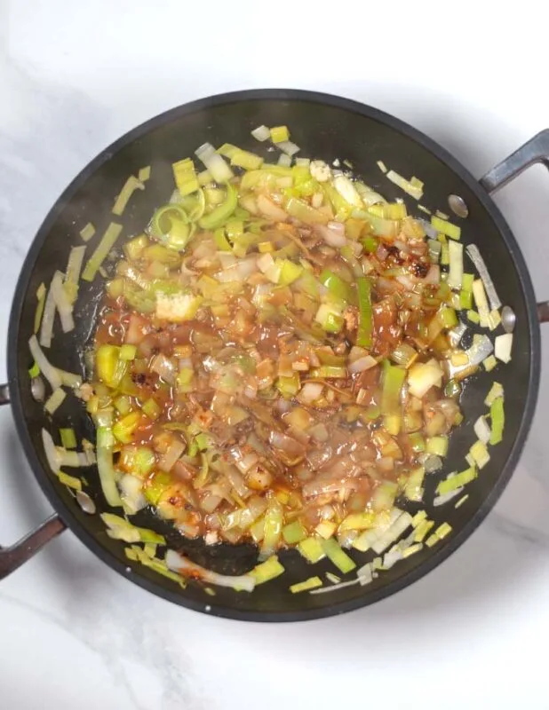 Miso and spices are mixed with the buttered leek.