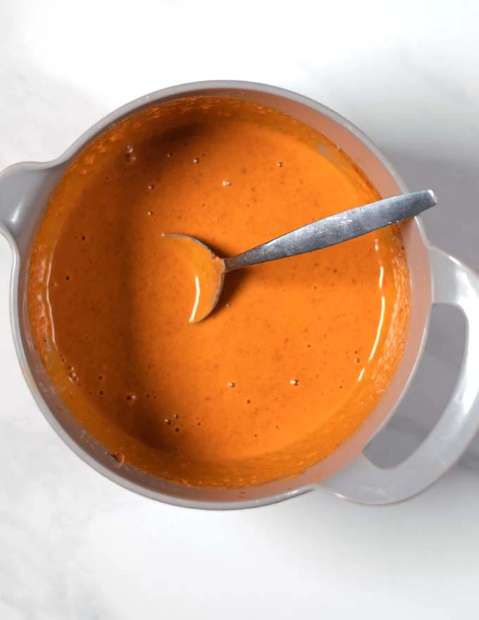 Ready peanut-lime dressing with a spoon.