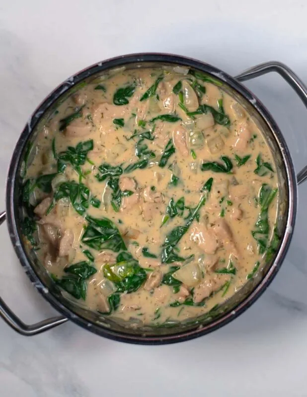 Fresh spinach is added to the Crack Chicken Soup.